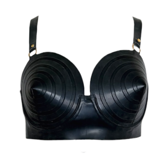 A black latex bra with dramatic, sculpted, concentric-ripple cups and shoulder straps with small gold hardware, shown against a plain white background.